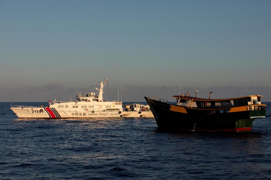 FILE PHOTO: A Chinese Coast Guard vessel blocks the Philippine resupply vessel Unaizah May 4, on its way to a resupply mission at Second Thomas Shoal in the South China Sea