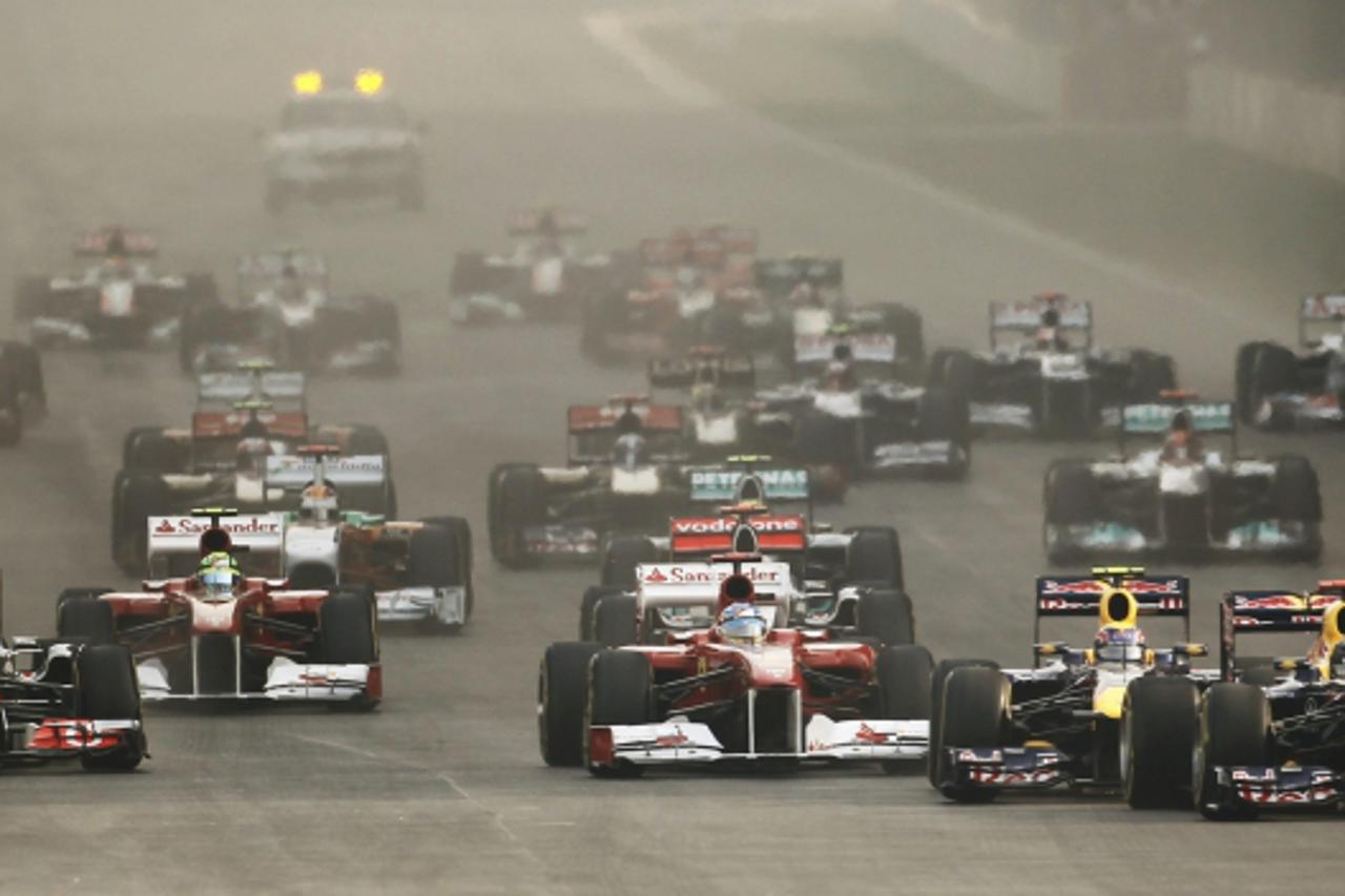 'REFILE - ADDING F1 KEYWORD    Red Bull Formula One driver Sebastian Vettel of Germany (R) leads the race at the start of the Indian first F1 Grand Prix at the Buddh International Circuit in Greater N