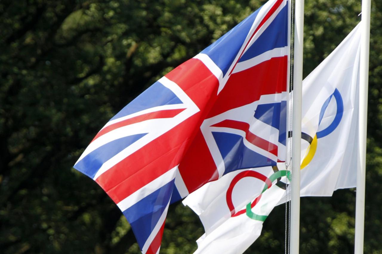 'The Union Jack (L) flies next to the Olympic flag during the torch lighting ceremony of the London 2012 Olympic Games at the site of ancient Olympia in Greece May 10, 2012. REUTERS/Mal Langsdon (GREE