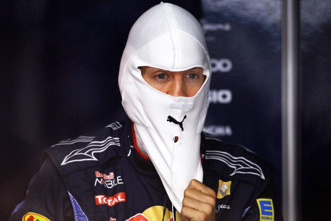 'Red Bull\'s German driver Sebastian Vettel is pictured in the pits of the Hockenheimring circuit on July 24, 2010 in Hockenheim, during the third free practice session of the Formula One German Grand