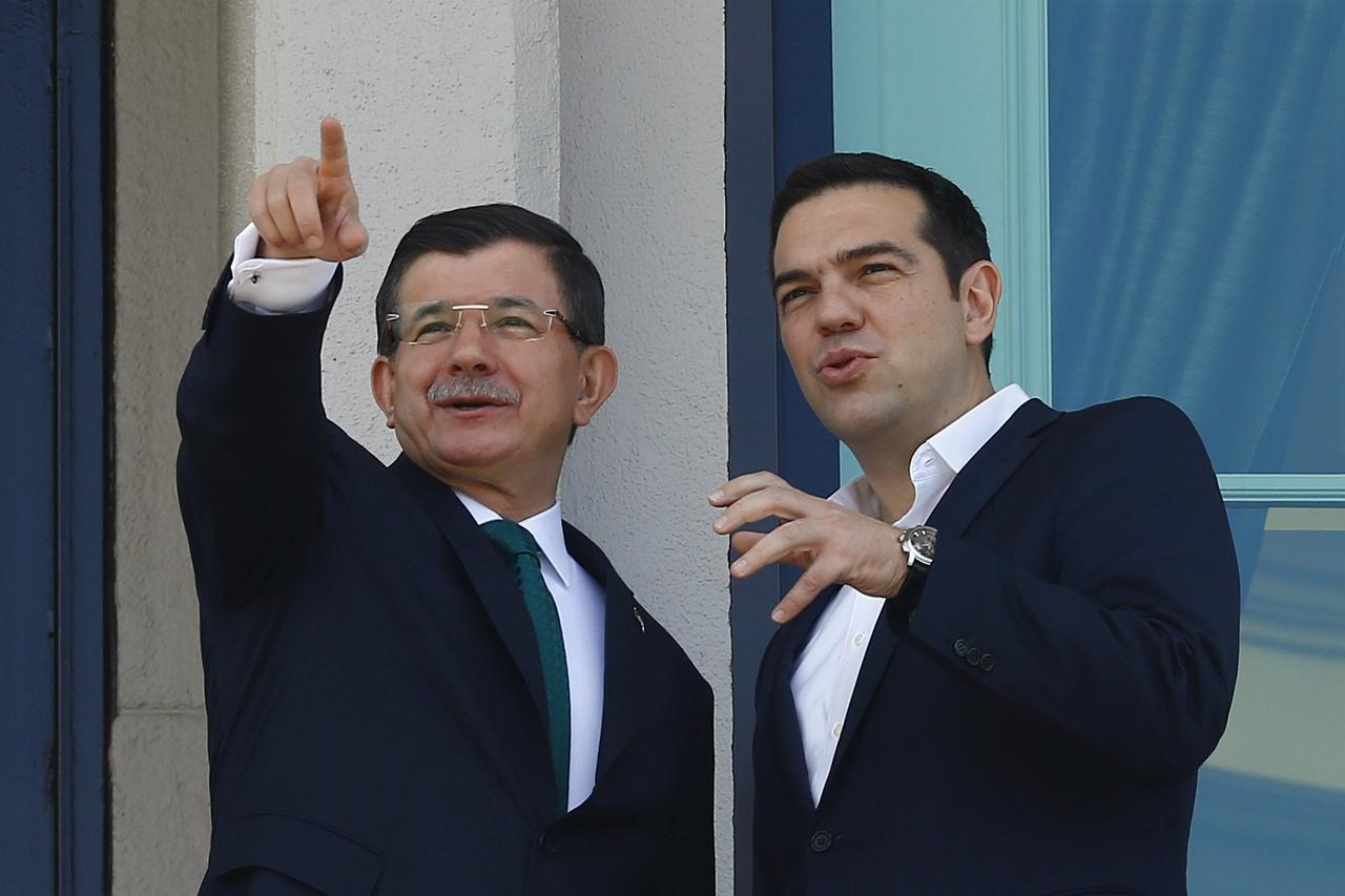 Turkish Prime Minister Ahmet Davutoglu (L) chats with his Greek counterpart Alexis Tsipras during their meeting in Ankara, Turkey, November 18, 2015.
