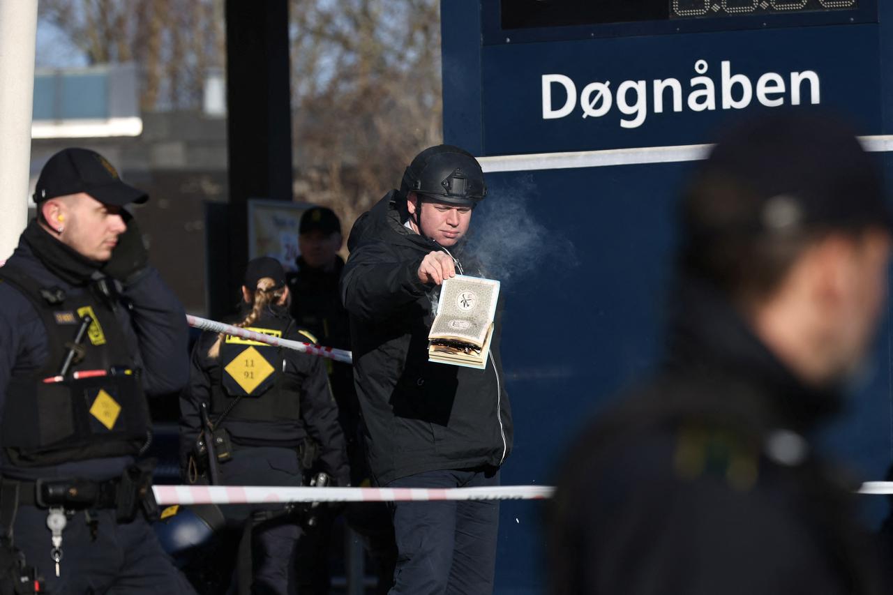 Far-right politician Rasmus Paludan burns a copy of Kuran in front of a mosque at Noerrebro, in Copenhagen