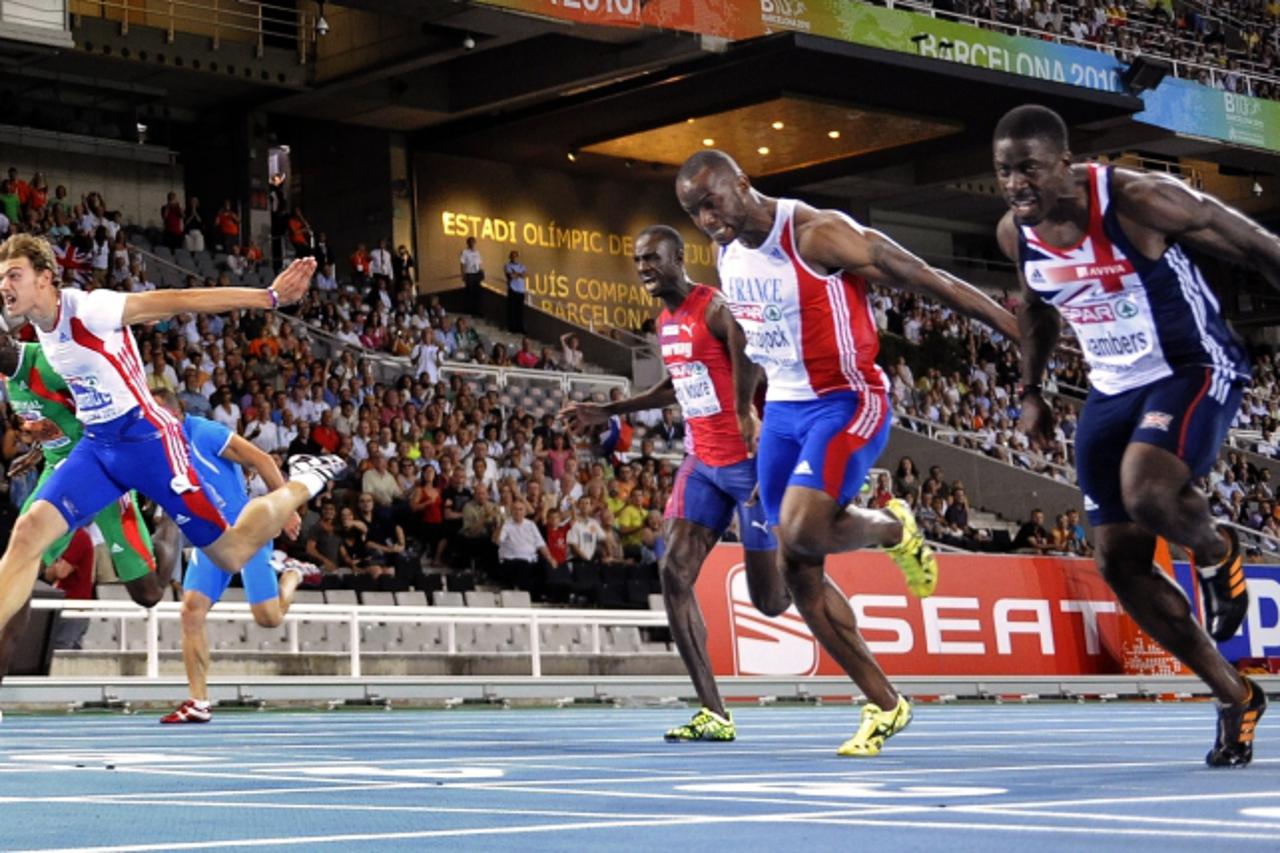 'France\'s Christophe Lemaitre (L) crosses first the finish line ahead off France\'s Martial Mbandjock (2ndR) and Great Britain\'s Dwain Chambers (L) as they compete in the men\'s 100m final at the 20