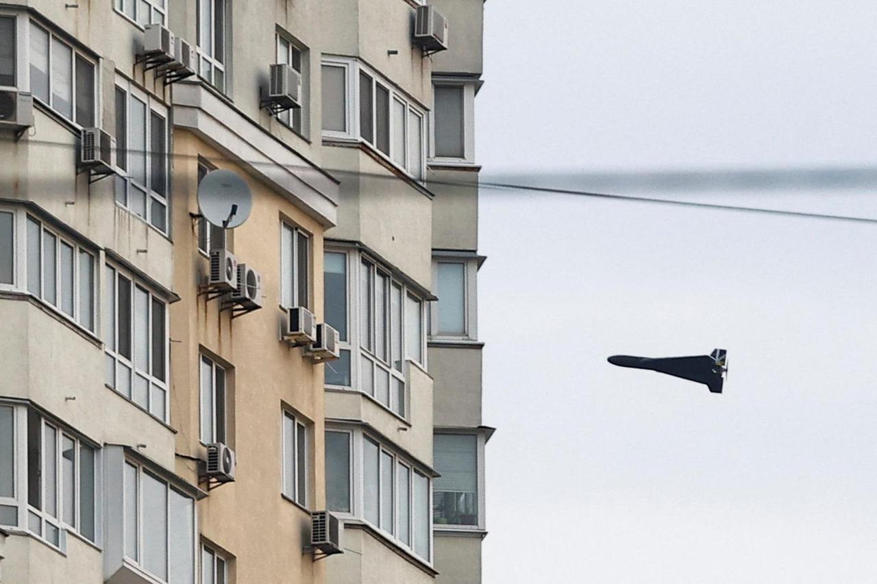 A Russian Geran 2 kamikaze drone flies next to a building, amid Russia's attack on Ukraine, in Kyiv