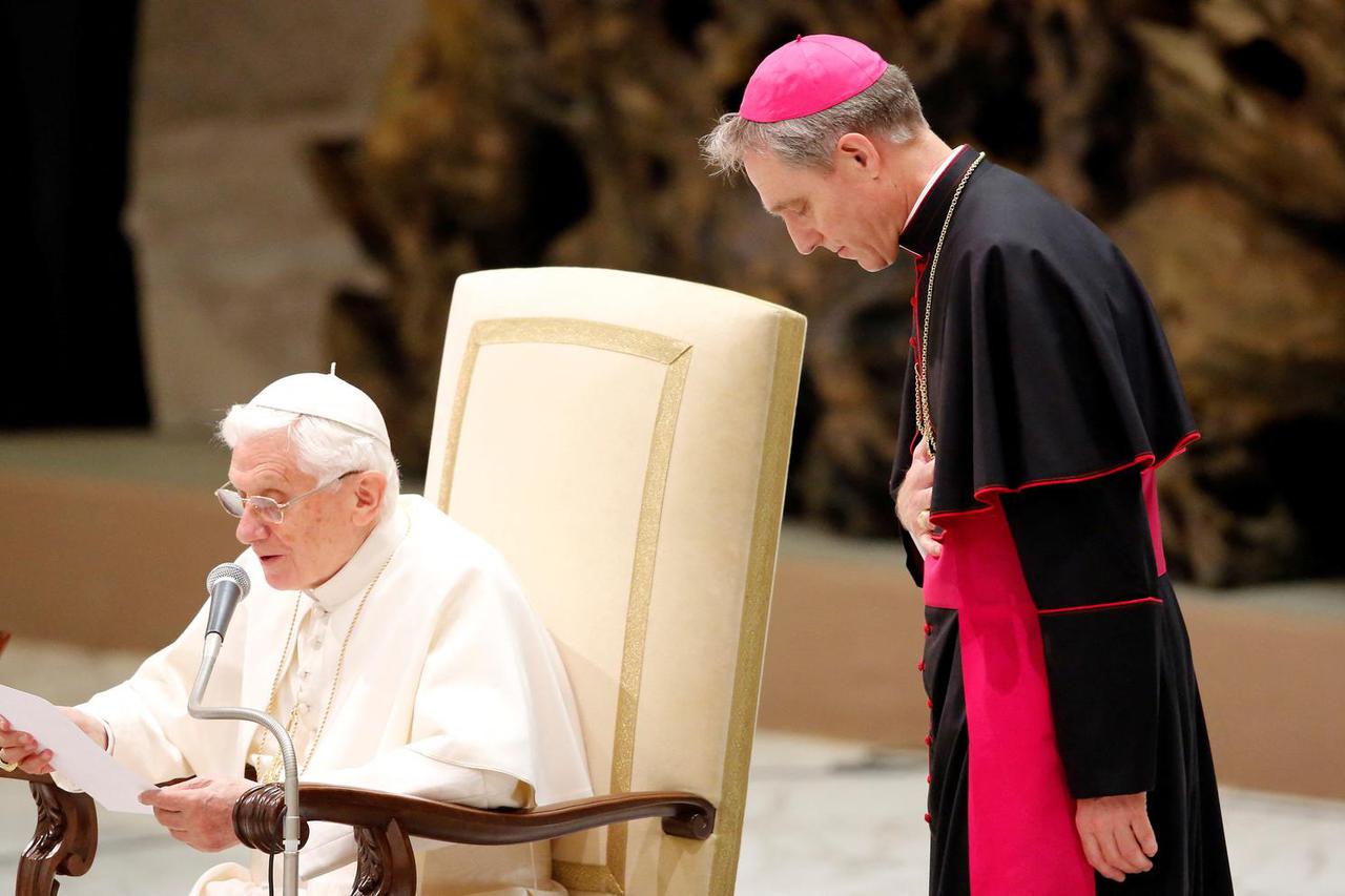 FILE PHOTO: Pope Benedict XVI speaks next to his private secretary Archbishop Georg Ganswein during the weekly audience in the Vatican
