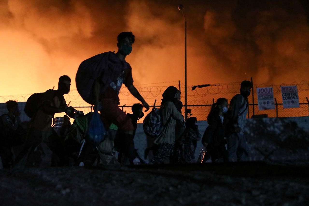 Refugees and migrants from the destroyed camp of Moria clash with the police on the island of Lesbos