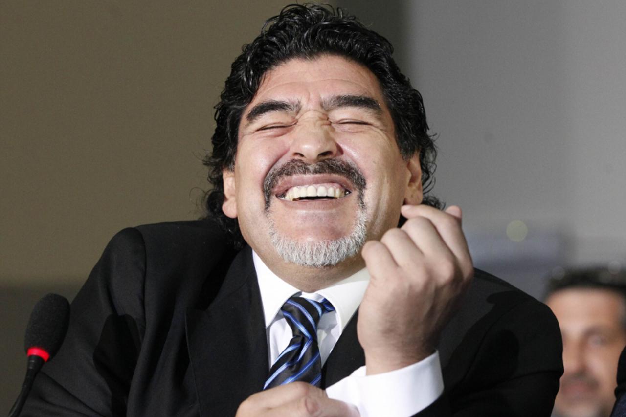 'Former Argentine soccer star Diego Maradona smiles during a news conference in Naples February 26, 2013.  REUTERS/Ciro De Luca (ITALY - Tags: SPORT SOCCER)'