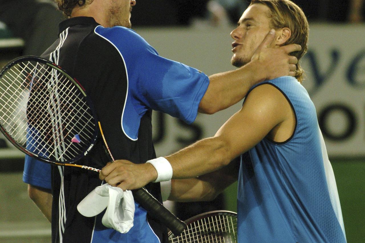 Marat Safin consoles Lleyton Hewitt