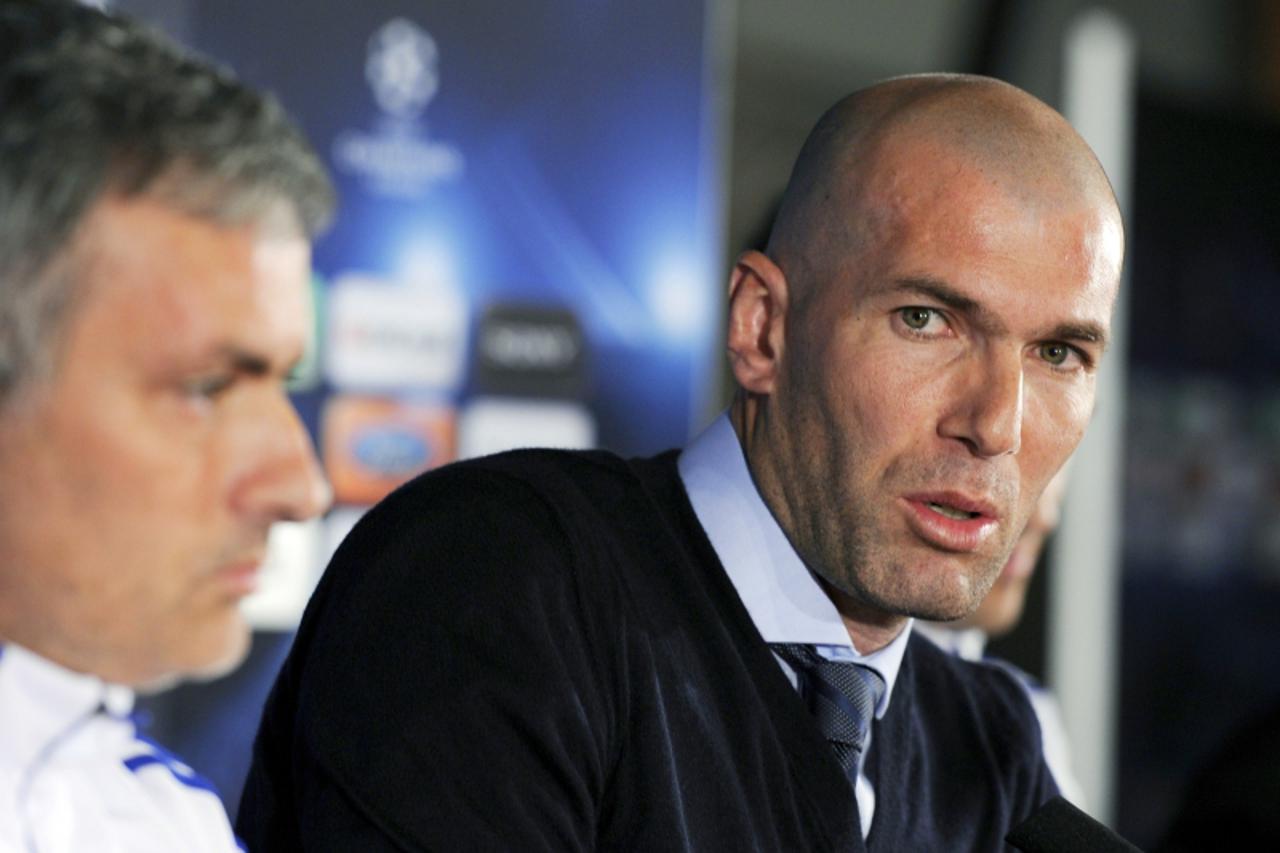 'Former French football player Zinedine Zidane speaks near Real Madrid\'s Portuguese coach Jose Mourinho (L) during a press conference on the eve of UEFA Champions league football match Lyon versus Re