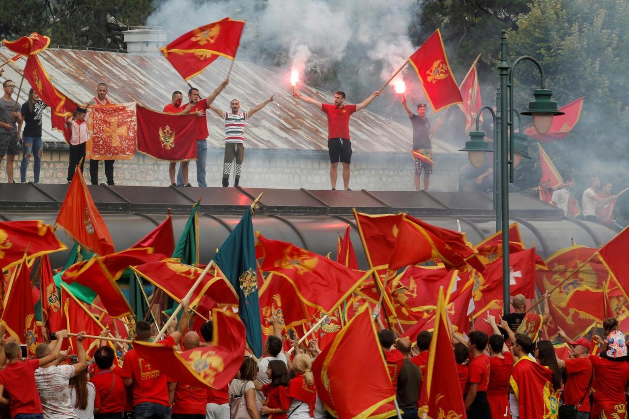 Members of Montenegrin nationalist groups wave Montenegrian flags during a rally in front of Cetinje monastery as a reaction to celebrations of pro-Serb nationalists after parliamentary elections last weekend, in Cetinje