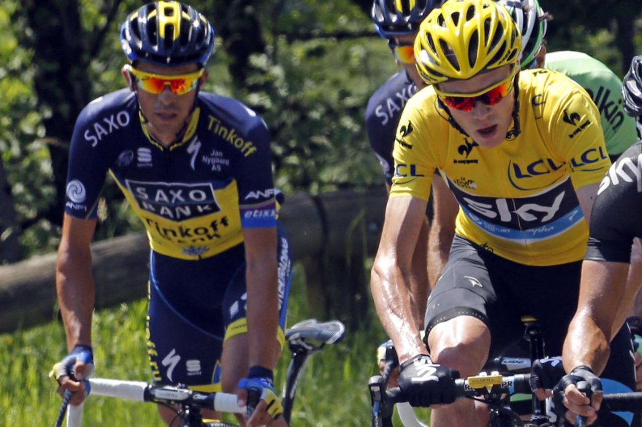 'Race leader yellow jersey holder Team Sky rider Christopher Froome of Britain (R) and Team Saxo-Tinkoff rider Alberto Contador of Spain (L) cycle as they climb the Mente pass during the 168.5 km nint