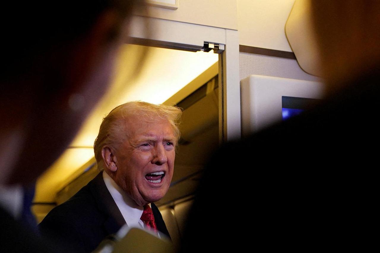 U.S. President Trump speaks to members of the media as he flies from Florida to Washington