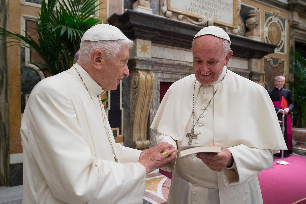 Former pope Benedict (L) is greeted by Pope Francis during a ceremony to mark his 65th anniversary of ordination to the priesthood at the Vatican June 28, 2016. Osservatore Romano/Handout via Reuters ATTENTION EDITORS - THIS IMAGE WAS PROVIDED BY A THIRD 