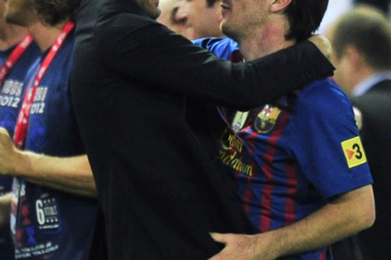 \'Barcelona\'s coach Josep Guardiola (L) embraces Barcelona\'s Argentinian forward Lionel Messi (R) at the end of the Spanish King\'s Cup final football match between Athletic Bilbao and FC Barcelona 
