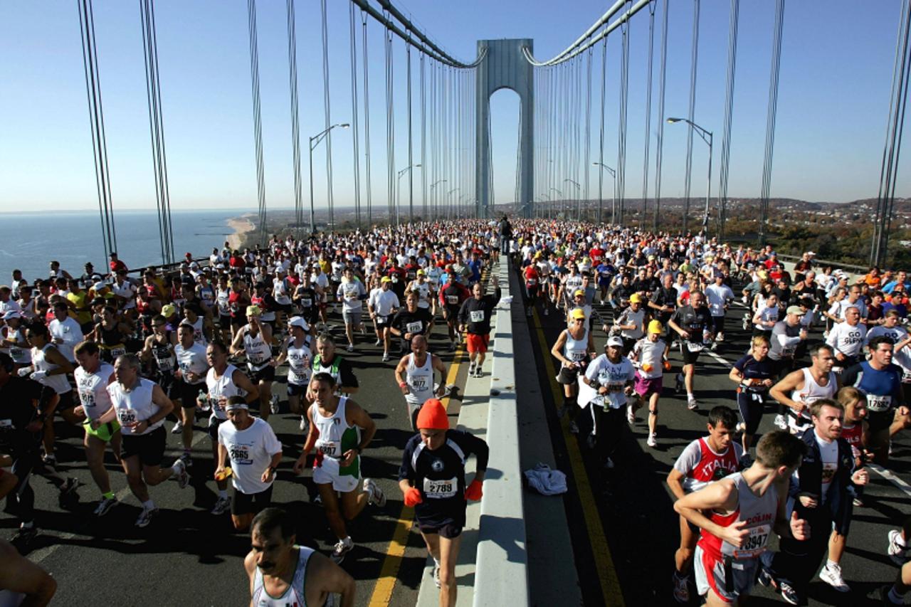 'NEW YORK - NOVEMBER 7:  Runners stream over the Verrazano Narrows Bridge at the start of the New York City Marathon November 7, 2004 in the Brooklyn borough of New York City. Nearly 35,000 runners pa