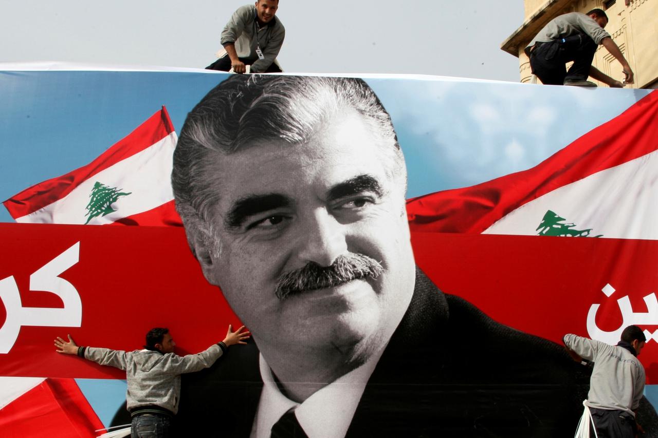 FILE PHOTO: Workers prepare a giant poster depicting Lebanon's assassinated former prime minister Rafik al-Hariri, in downtown Beirut