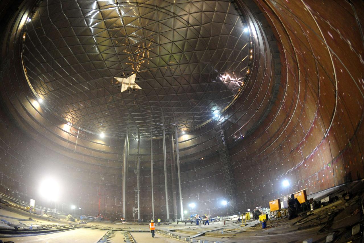 A worker walks inside a gas tank under construction at Poland's first liquefied natural gas (LNG) terminal, in the Baltic port of Swinoujscie July 23, 2014. Poland is building the terminal at at a cost of around 3 billion zlotys ($977.2 million). It will 