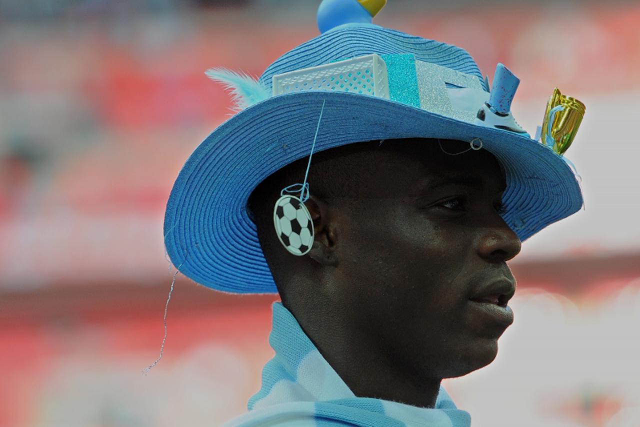'Manchester City\'s Italian footballer Mario Balotelli wears a hat following his team\'s victory over Stoke during the FA Cup final football match between Manchester City and Stoke City at Wembley Sta