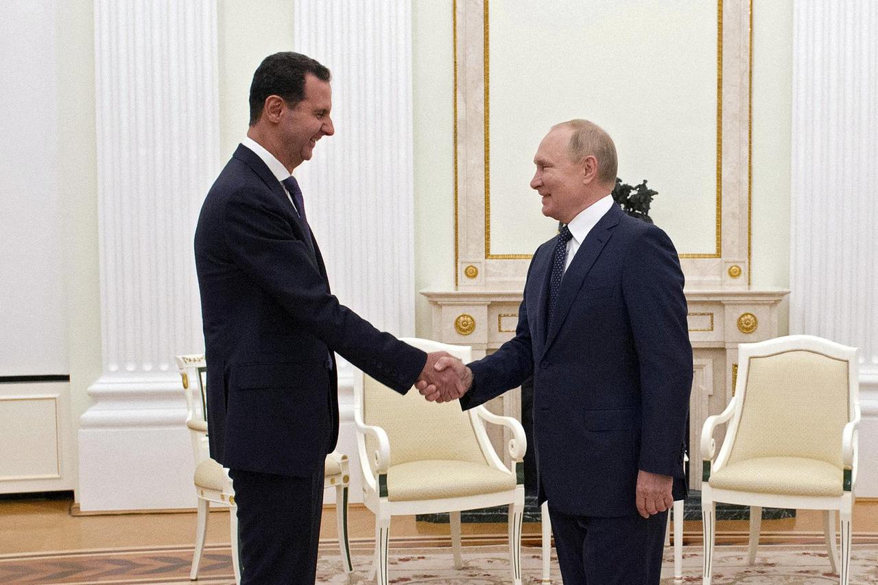 FILE PHOTO: Russian President Vladimir Putin meets with Syrian President Bashar al-Assad in Moscow