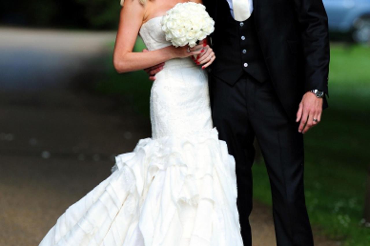 'Footballer Peter Crouch and model Abbey Clancy in the grounds of Stapleford Park in Leicester following their wedding. Photo: Press Association/Pixsell'