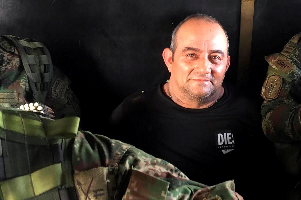 Dairo Antonio Usuga David, alias "Otoniel", top leader of the Gulf clan, poses for a photo while escorted by Colombian military soldiers inside a helicopter after being captured, in Turbo