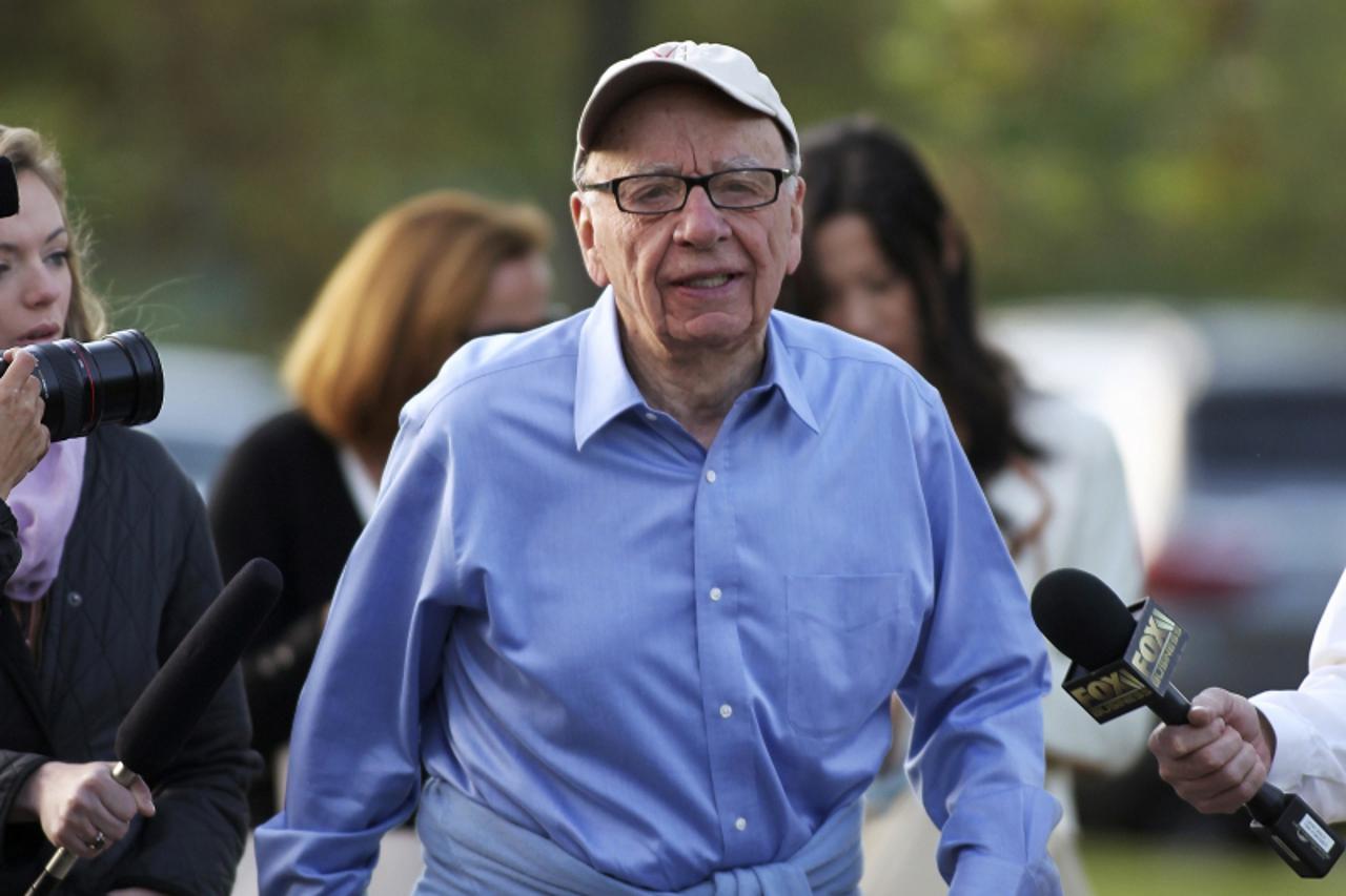 'Rupert Murdoch, Australian-American media mogul and the Chairman and CEO of News Corporation, speaks briefly to the media as he arrives at the Sun Valley Inn before the start of the second day of the