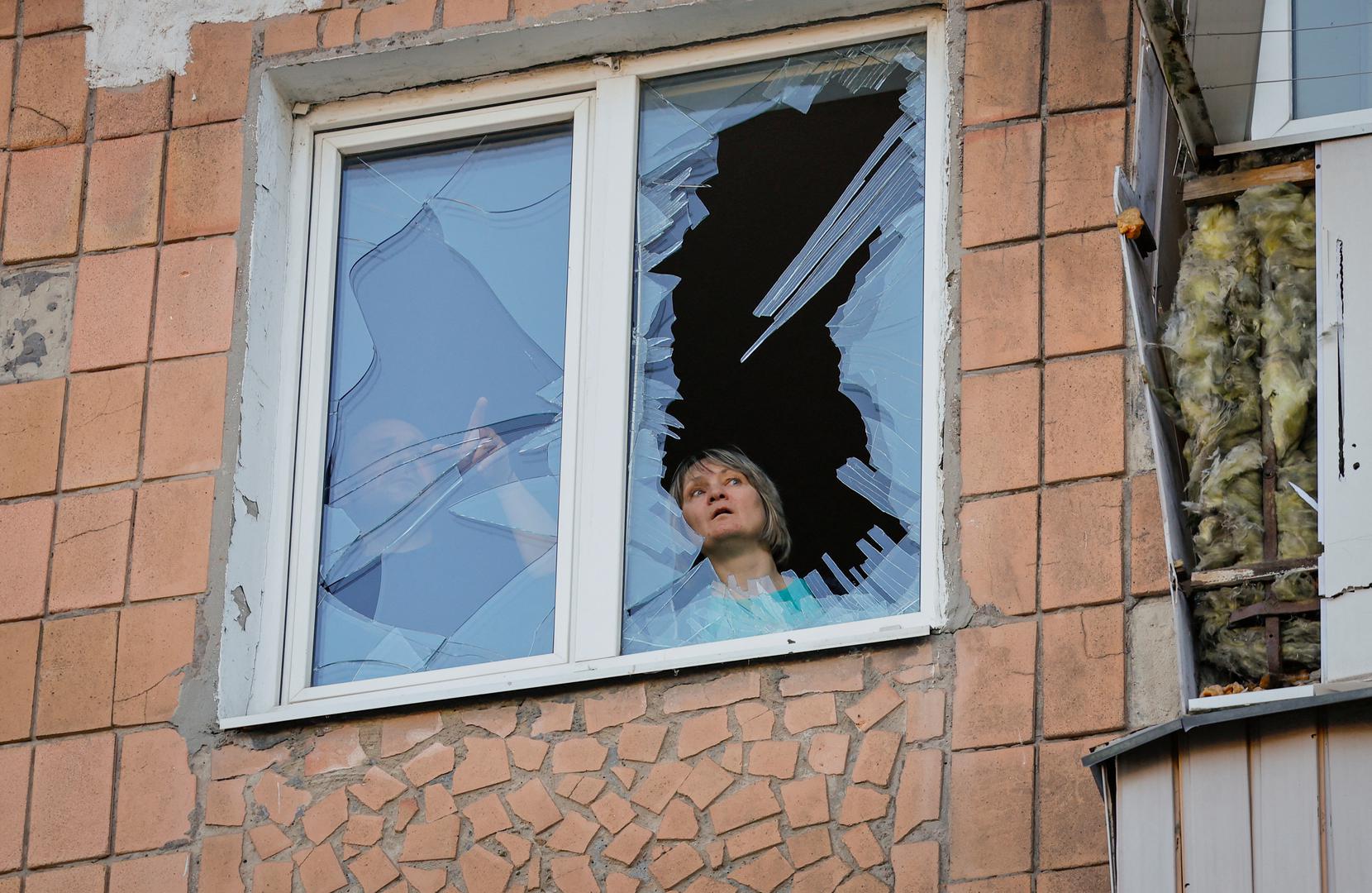 Local residents look out of a window, which was damaged during a recent shelling in the course of the Russia-Ukraine conflict, in Donetsk, Russian-controlled Ukraine, April 6, 2024. REUTERS/Alexander Ermochenko Photo: Alexander Ermochenko/REUTERS