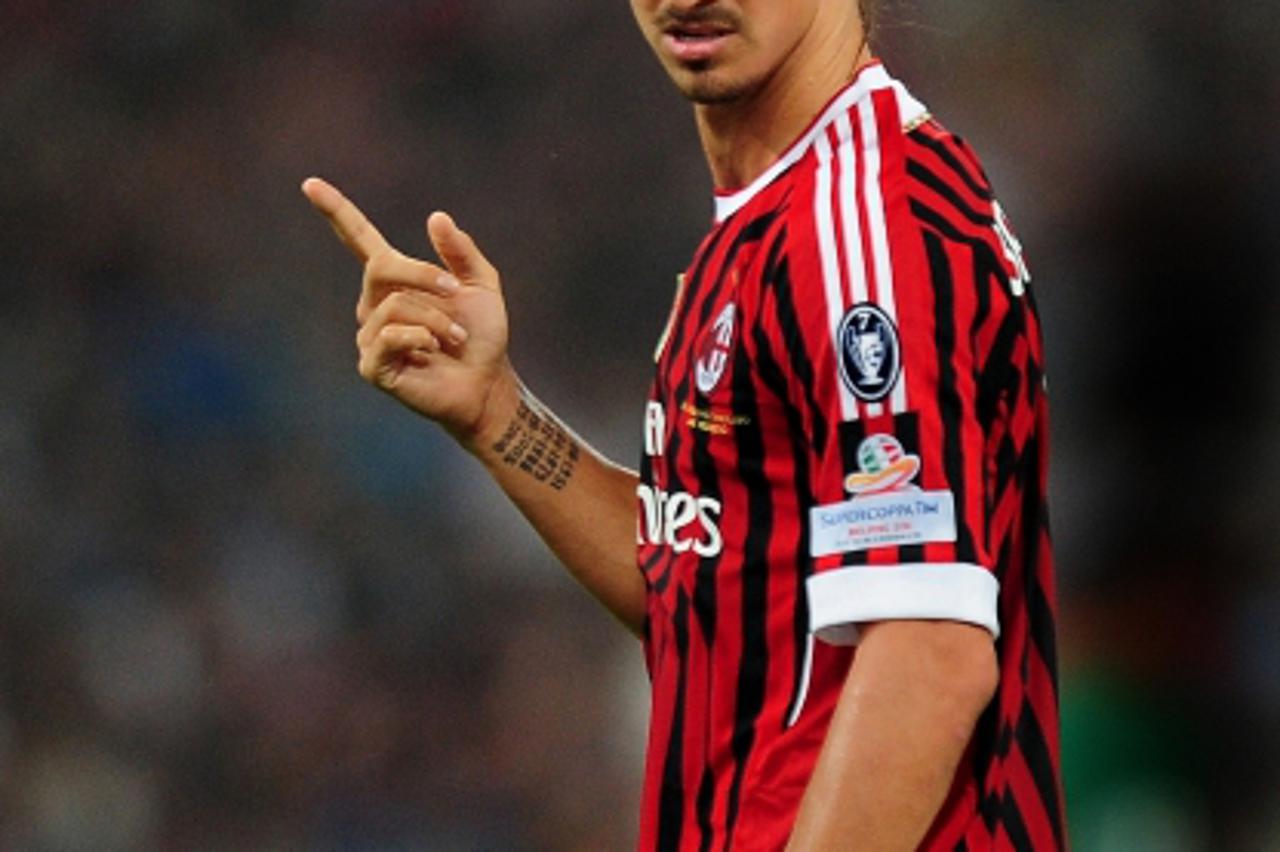 'AC Milan\'s Zlatan Ibrahimovic of Sweden reacts during the Italian Super Cup 2011 football match against Inter Milan, at China\'s National Stadium, known as Bird\'s Nest, in Beijing on August 6, 2011