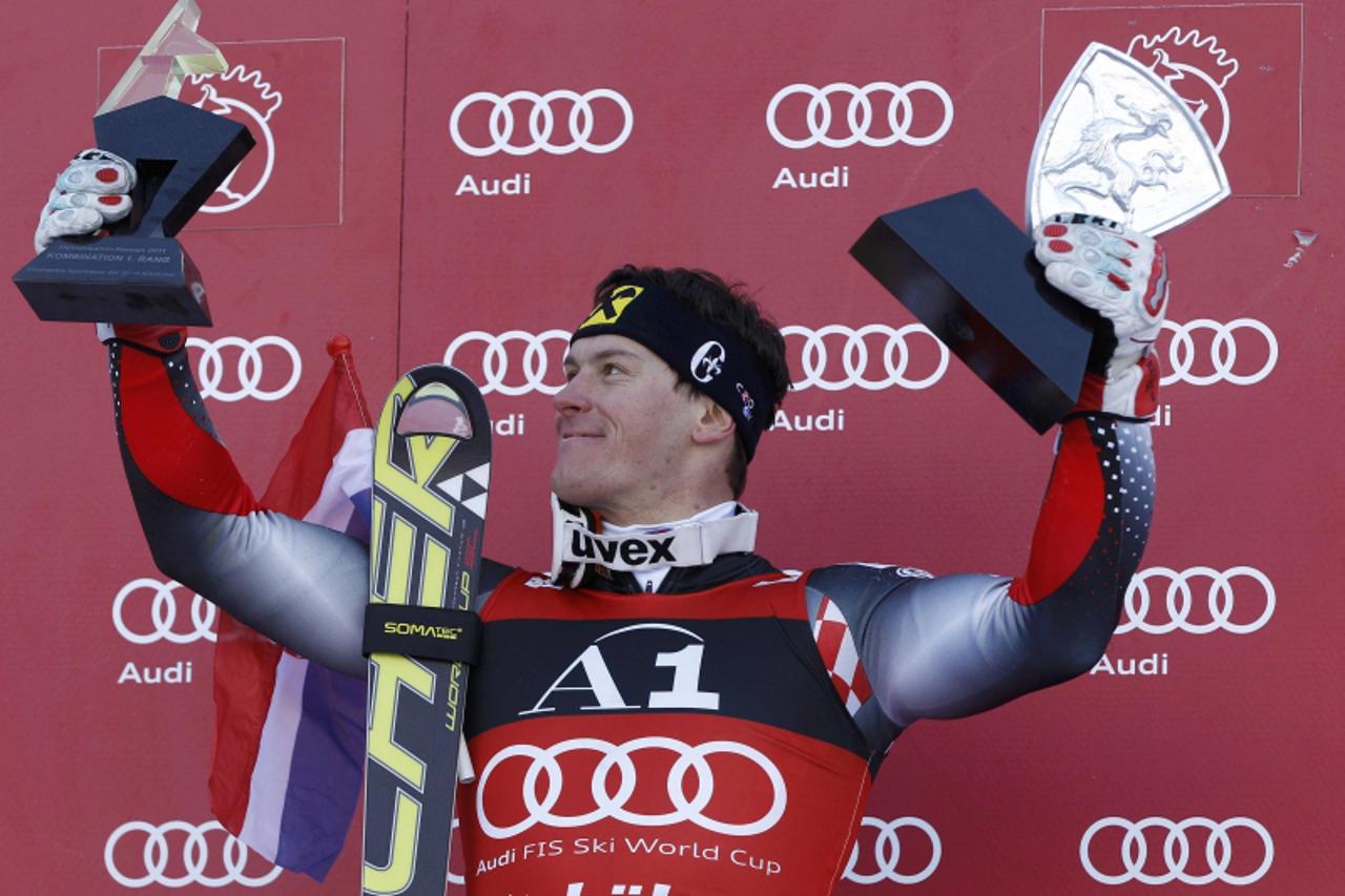 'Ivica Kostelic of Croatia holds up his trophies as he celebrates after the men\'s slalom race at the Alpine Skiing World Cup on Hahnnenkamm mountain in Kitzbuehel January 23, 2011. Jean-Baptiste Gran