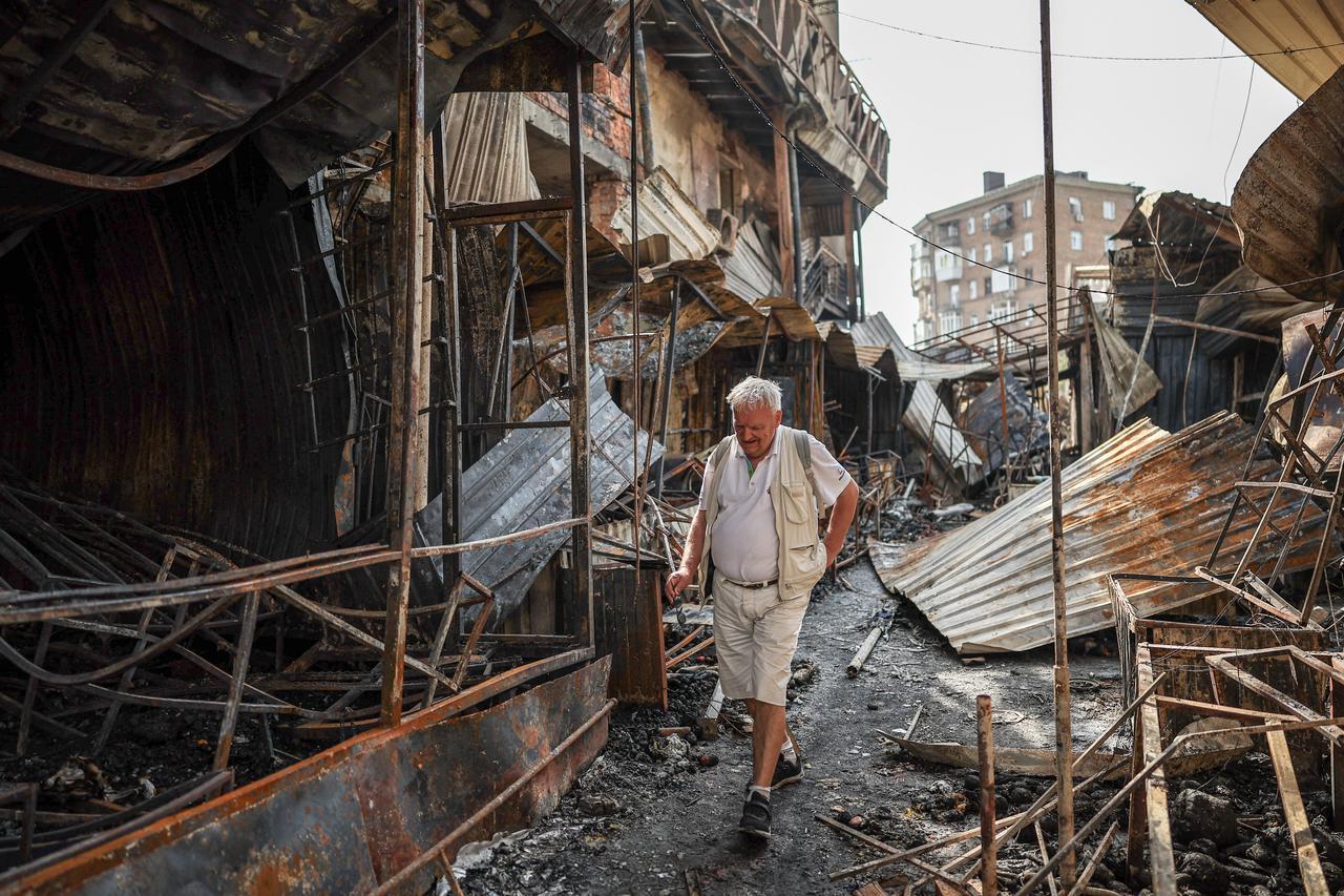 Residents wander around a site of a Russian attack in Kyiv