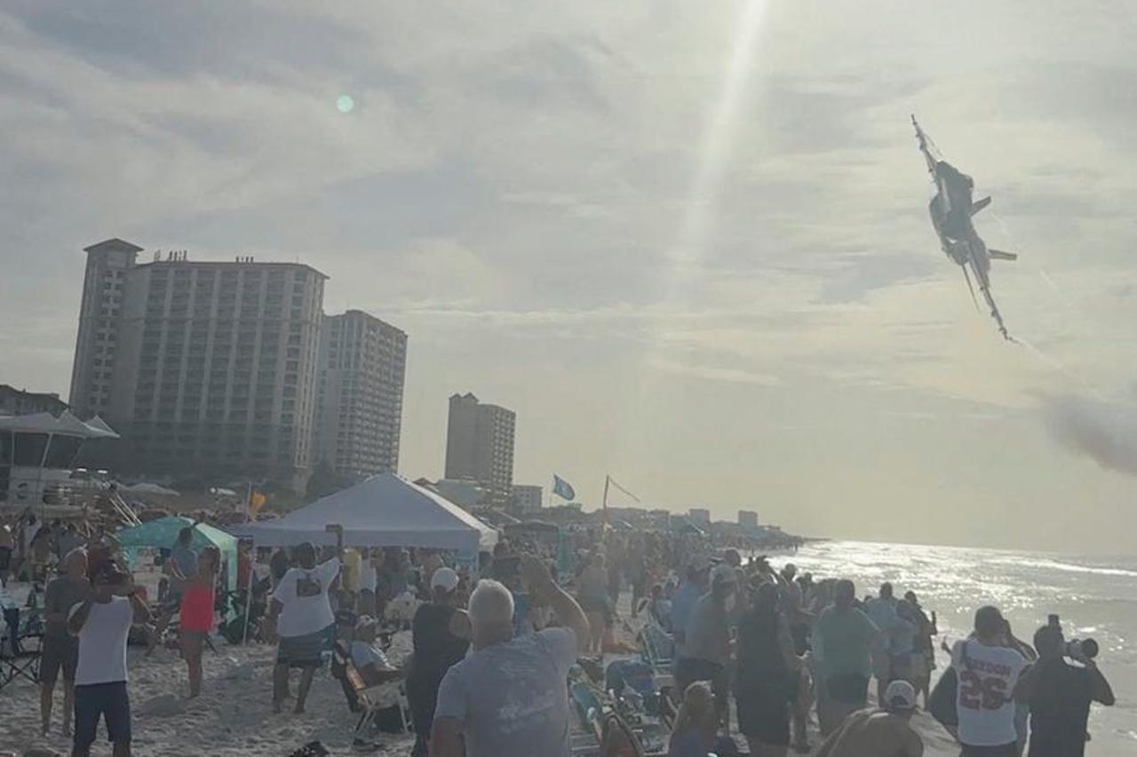 A Navy Blue Angels jet flies low over the crowd on Pensacola Beach
