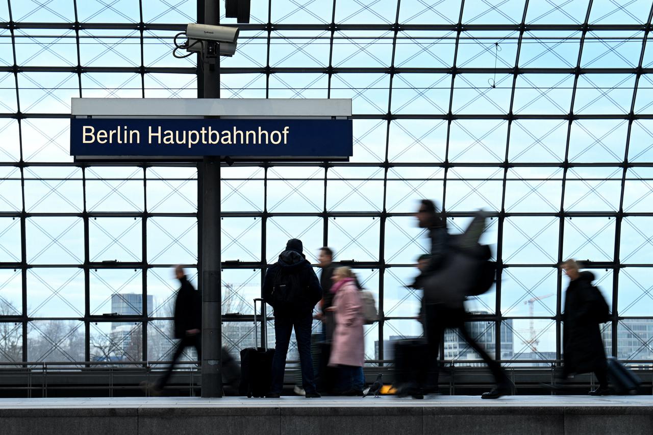 People make their way with their luggage through the main train station, as the annual festive Christmas holidays near in Berlin