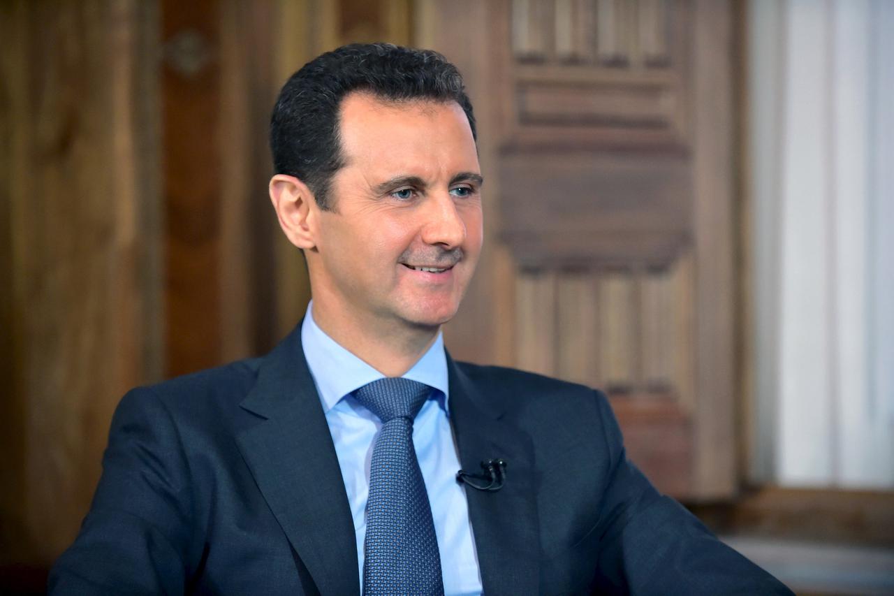 Syria's President Bashar al-Assad answers questions during an interview with al-Manar's journalist Amro Nassef, in Damascus, Syria, in this handout photograph released by Syria's national news agency SANA on August 25, 2015.  Syrian President Bashar al-As