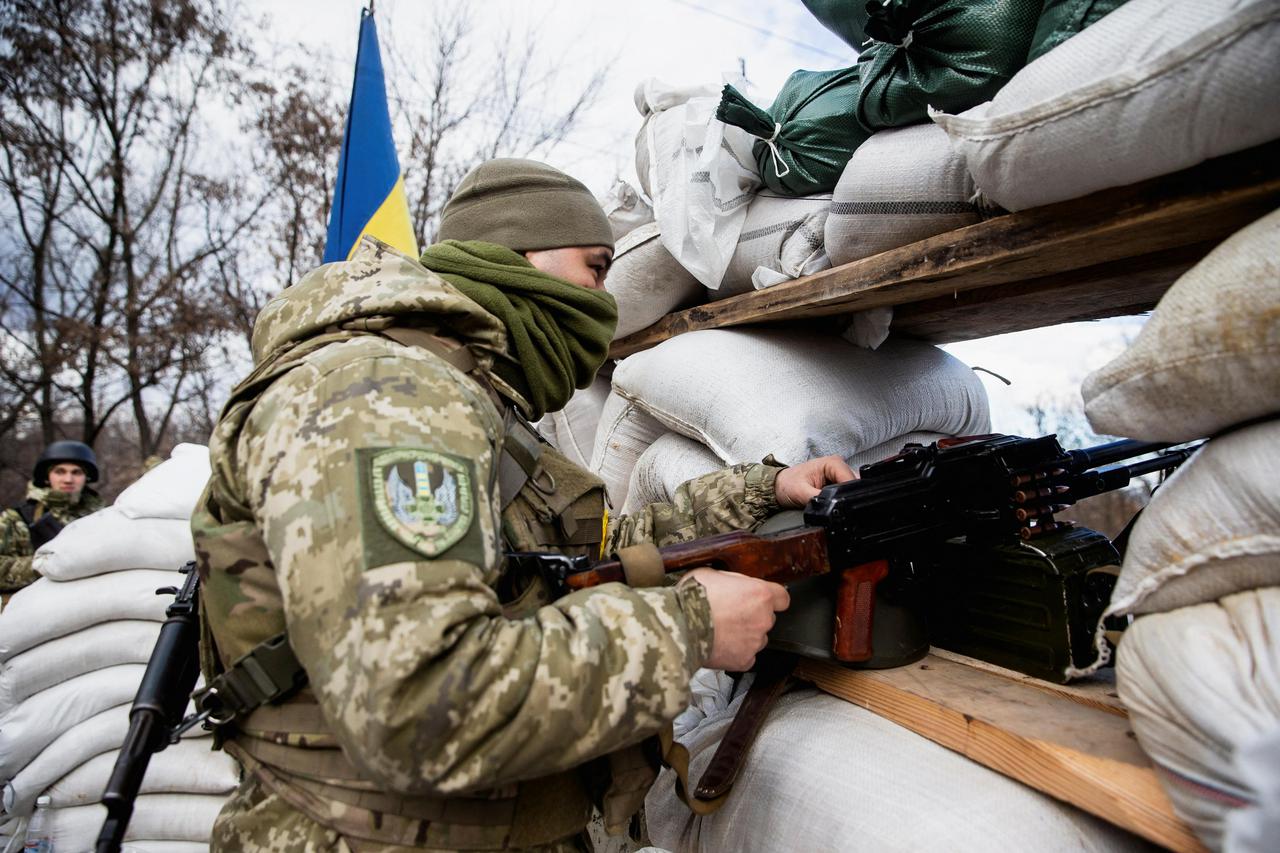 A Ukrainian service member is seen at a check point in Zhytomyr
