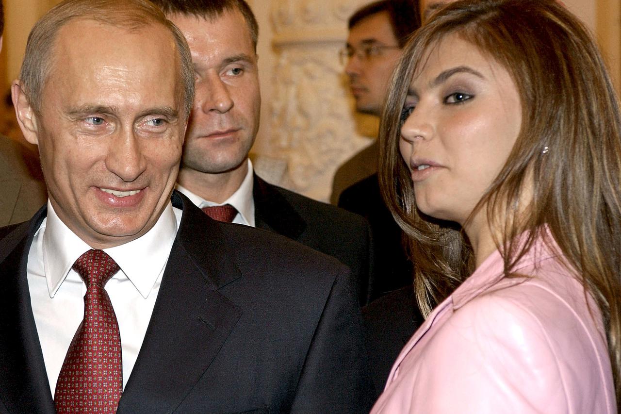 Russian President Vladimir Putin (L) smiles next to Russian gymnast Alina Kabaeva during a meeting with the Russian Olympic team at the Kremlin in Moscow, Russia in this November 4, 2004 file photo. REUTERS/ITAR-TASS/PRESIDENTIAL PRESS SERVICE/Files      