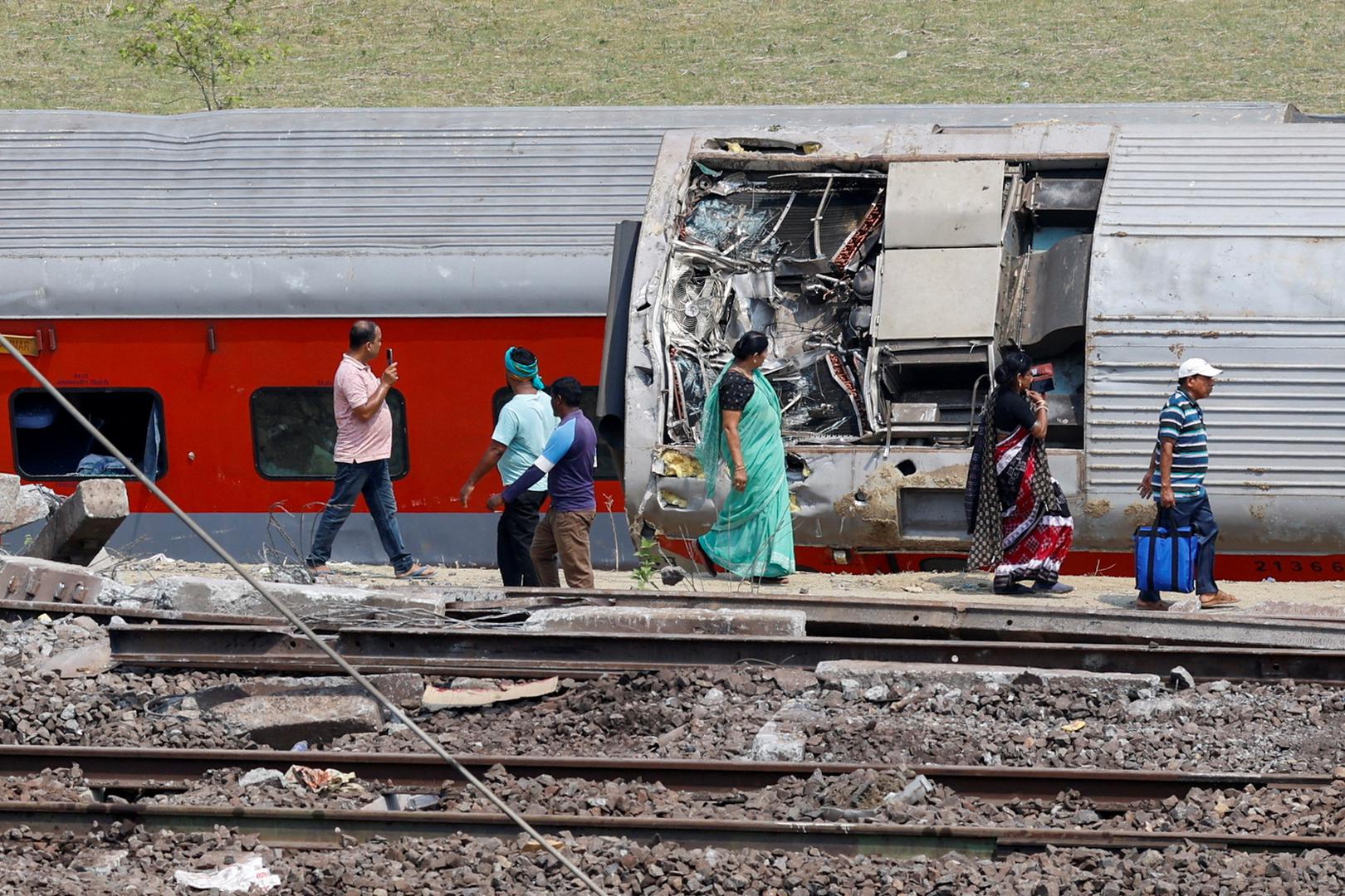 People walk past a damaged coach at the site of a train collision following the accident in Balasore district in the eastern state of Odisha, India, June 4, 2023. REUTERS/Adnan Abidi Photo: ADNAN ABIDI/REUTERS