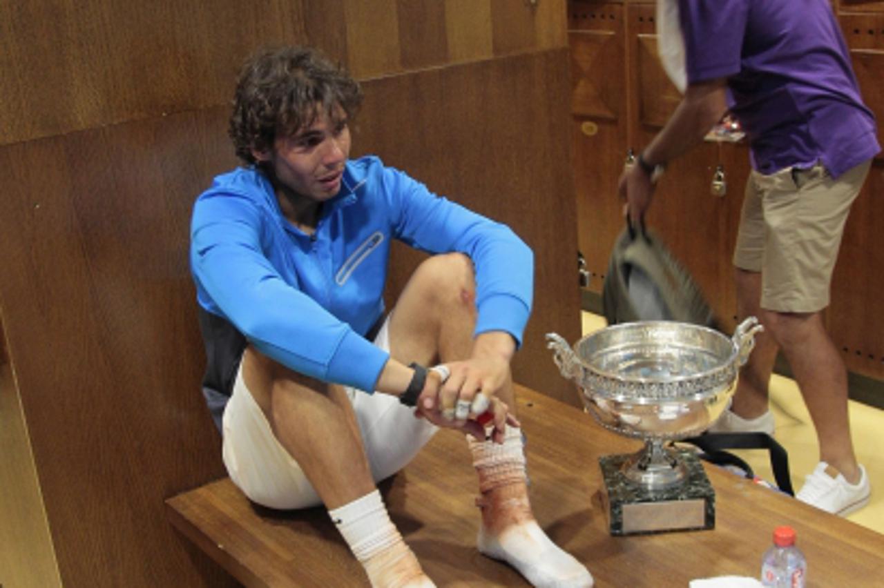 'Spain\'s Rafael Nadal is seen in the rest room after winning over Switzerland\'s Roger Federer in the men\'s final in the French Open tennis championship at the Roland Garros stadium, on June 5, 2011