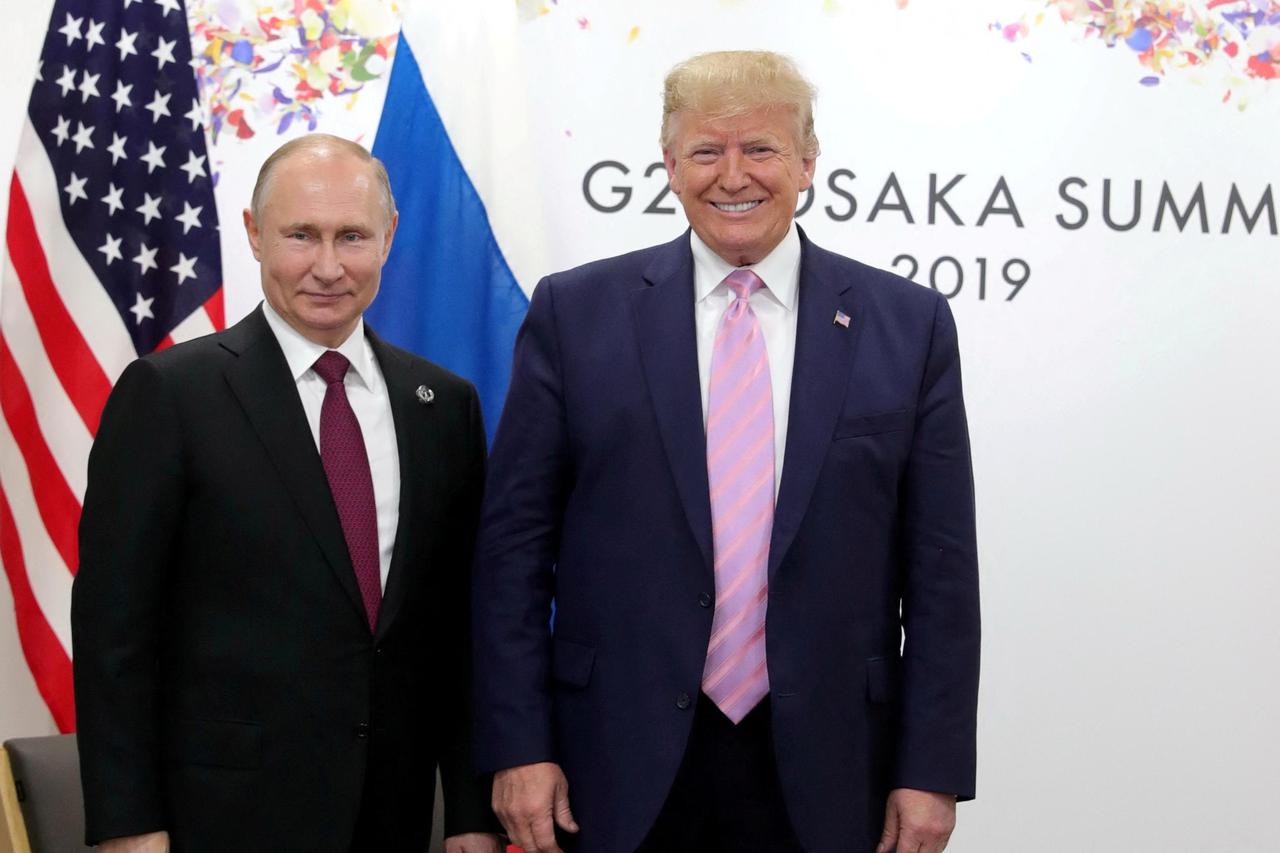 FILE PHOTO: Russia's President Vladimir Putin and U.S. President Donald Trump attend a meeting on the sidelines of the G20 summit in Osaka