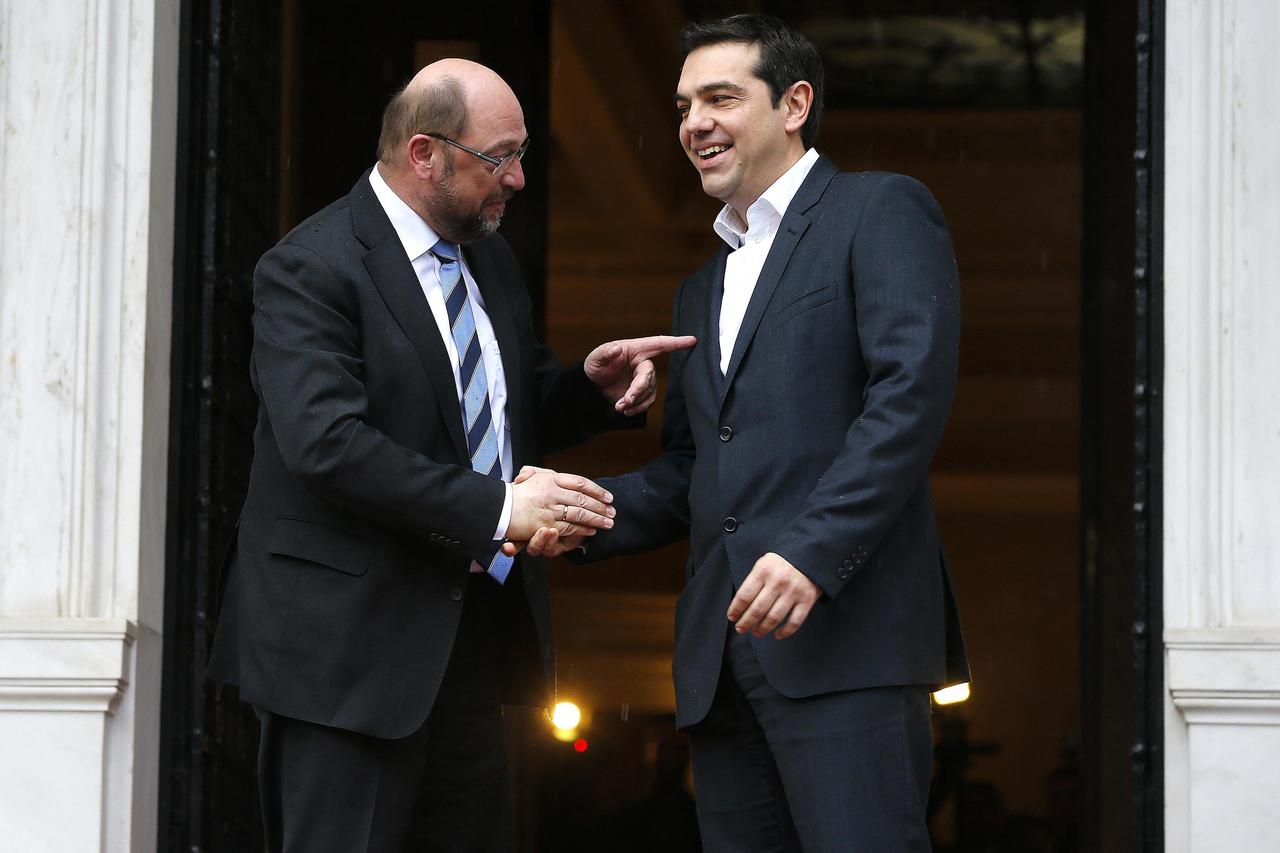 European Parliament President Martin Schulz (L) points out that Greek Prime Minister Alexis Tsipras does not wear a tie, outside the Greek Premier's office in Athens January 29, 2015. Schulz warned leftist Tsipras on Wednesday against diverging from the E