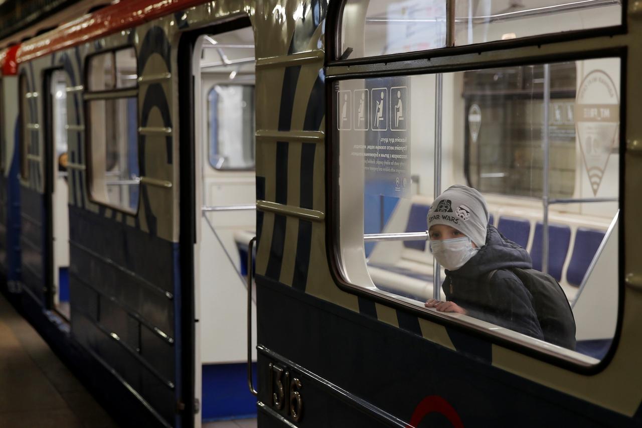 A boy looks out of the train window during a partial lockdown in Moscow