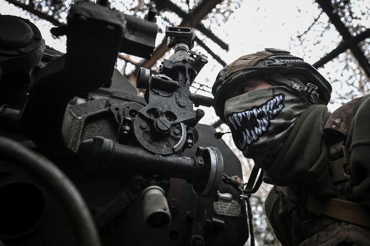 Ukrainian servicemen fire a howitzer towards Russian troops near the frontline town of Pokrovsk