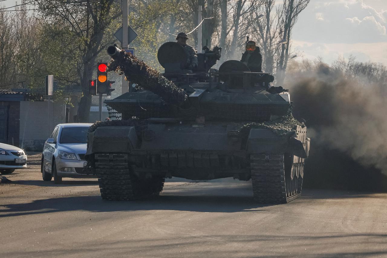 FILE PHOTO: Russian army servicemed drive a tank on a street in Donetsk