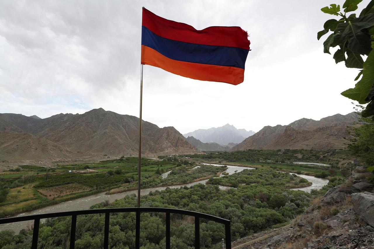 The Armenian flag flies on a viewpoint above the Aras River in the Syunik Province