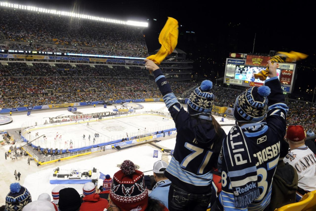 'Pittsburgh Penguins fans cheer on their team in the first period against the Washington Capitals during the NHL\'s Winter Classic hockey game at Heinz Field in Pittsburgh, Pennsylvania January 1, 201