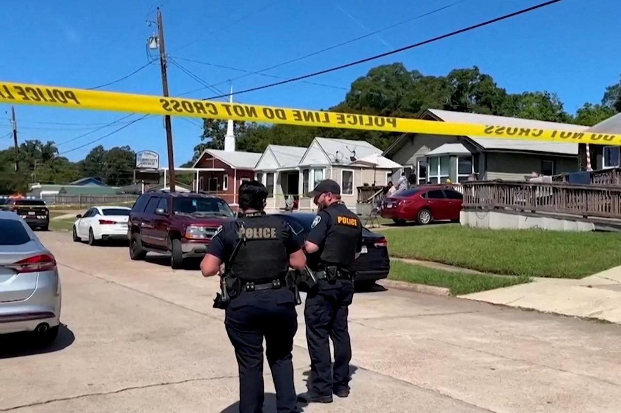 Police officers secure the scene where eight children, with ages ranging from 1 to 14, were killed in a mass shooting in Shreveport