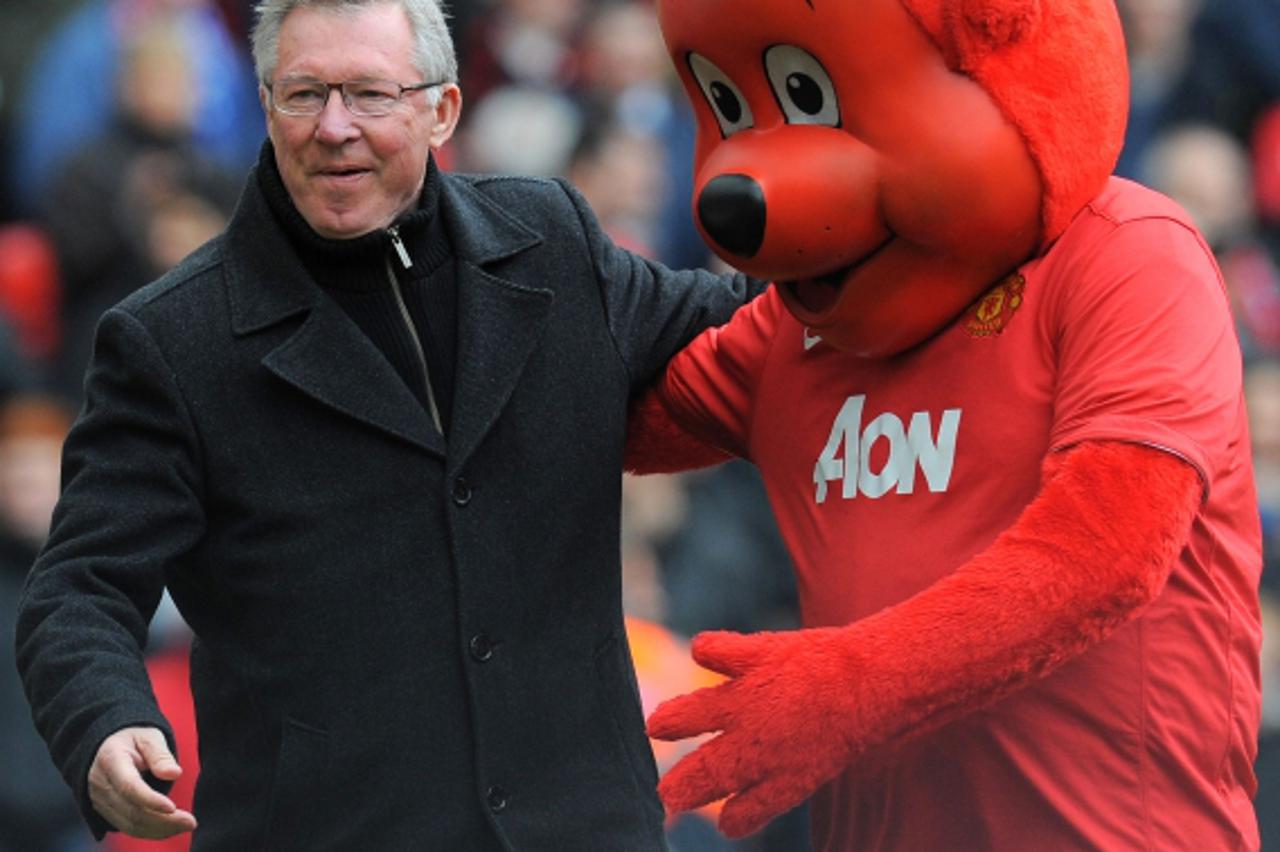 'Manchester United manager Alex Ferguson (L) greets mascot Fred the Red before the English Premier League football match between Manchester United and Queens Park Rangers at Old Trafford in Manchester
