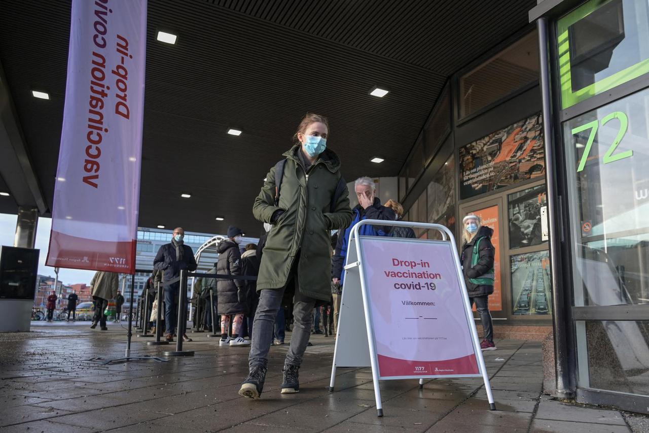 People queue for a drop-in vaccination at Stockholm City Terminal station