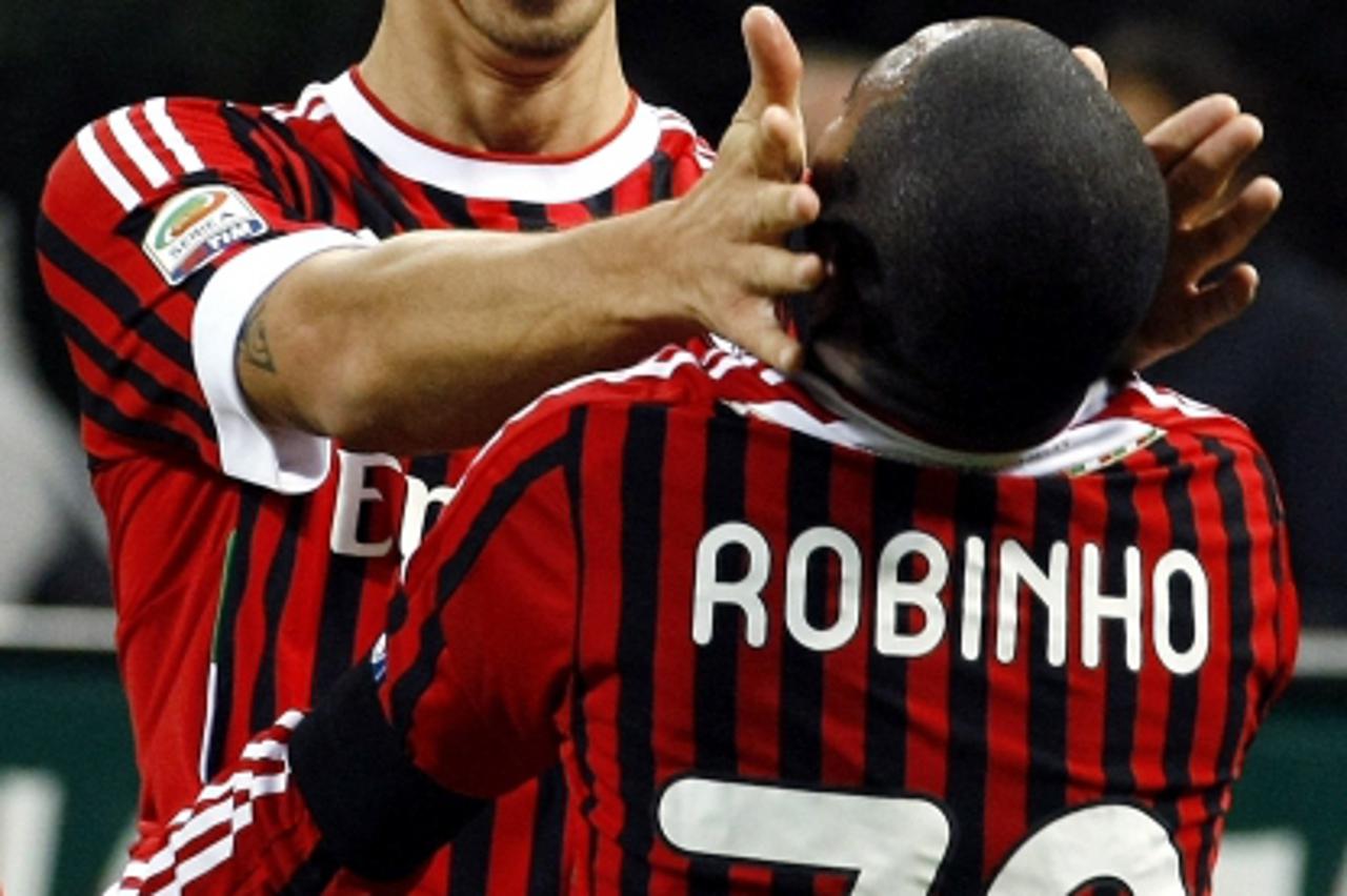 'Ac Milan\'s Robinho (R) is celebrated by his team mate Zlatan Ibrahimovic after scoring a second goal against Palermo during their Italian Serie A soccer match at the San Siro stadium in Milan Octobe