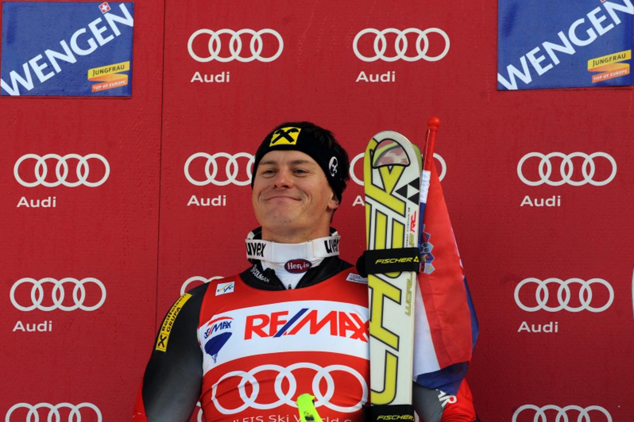 \'Croatia\'s Ivica Kostelic celebrates his victory during the podium ceremony of the FIS World Cup Men\'s Super combined in Wengen on January 14, 2011.     AFP PHOTO / DIMITAR DILKOFF\'