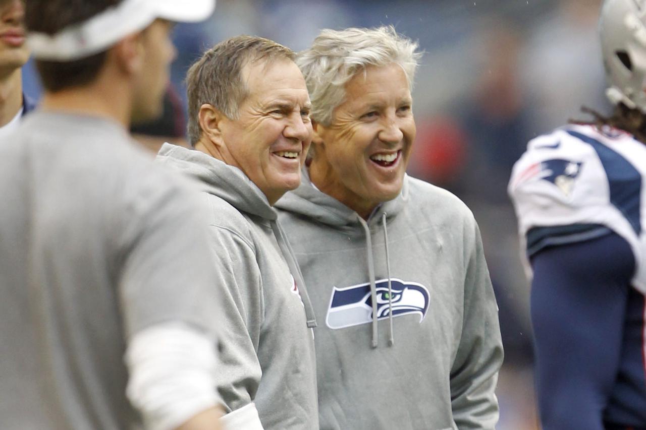 Oct 14, 2012; Seattle, WA, USA; New England Patriots head coach Bill Belichick and Seattle Seahawks head coach Pete Carroll talk during pregame warmups at CenturyLink Field. Mandatory Credit: Joe Nicholson-US PRESSWIRE 